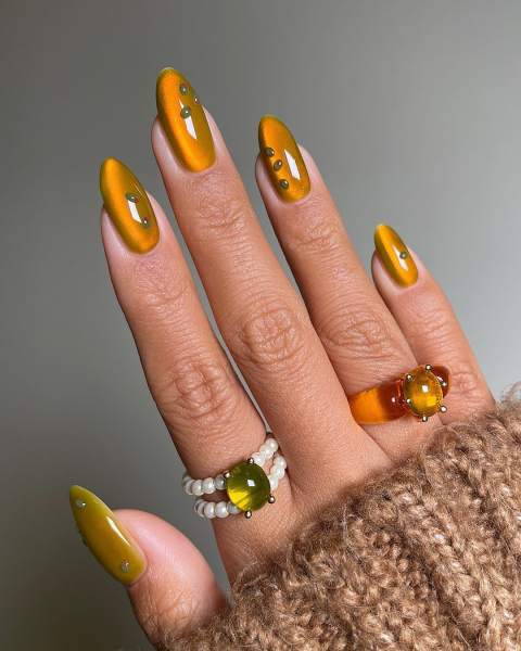 Close up of yellow and green nails with green studs