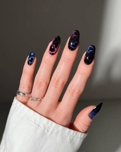 Close up of black and blue velvet manicure